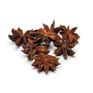 Whole star anise in a clear package, label visible, placed on a rustic wooden table.