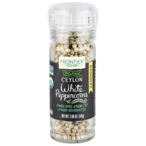Frontier Co-op Organic Ceylon White Peppercorns in a glass bottle with a grinder top, featuring a mild pepper flavor for white sauces and other dishes.