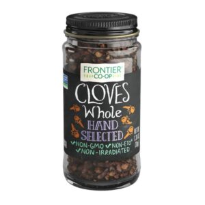 Whole cloves from Frontier® in a glass jar with a label, showcasing their rich aroma and hand-selected quality.