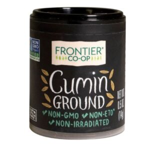 Organic cumin powder in a packaging with a clear label and a glass container.