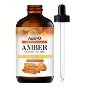 Amber Essential Oil 2.11fl oz bottle displayed with amber resin and spa accessories for skin, hair, and nail care.