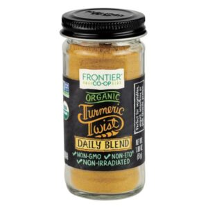 Frontier Co-op Organic Turmeric Spice Blend in a glass bottle with metal cap, featuring turmeric, cinnamon, ginger, and cardamom.