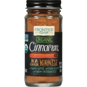 A spoonful of Frontier Co-op® Organic Ground Korintje Cinnamon showing its fine powder texture.