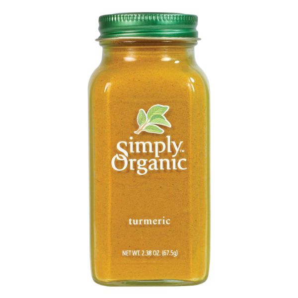 Adding Simply Organic Ground Turmeric to a dish.