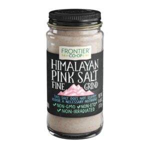 Himalayan pink salt in a 0.6 lb glass bottle with a metal cap, showcasing fine grain texture.