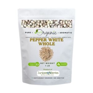 Grinding whole white peppercorns over creamy soup